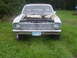 1966 Ford Ranchero - Front view of a weathered 1966 Ford Ranchero parked on grass, with its hood raised.