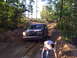 1992 Ford Bronco - Ford Bronco navigates a challenging off-road course through a wooded area.