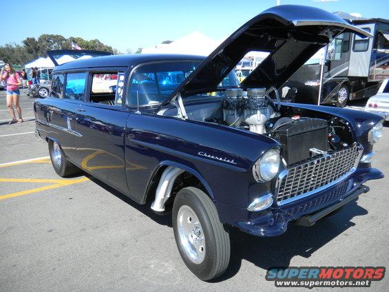 Dark blue 1955 Chevrolet station wagon, hood open, showing engine