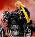 1999 Ford Crown Victoria - A woman in leather poses on a black motorcycle with a yellow scarf.