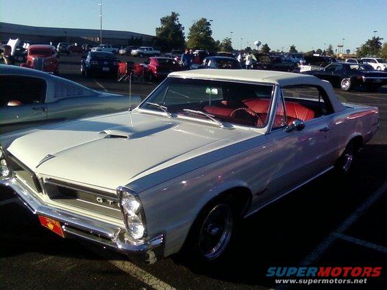 White convertible with red interior, front grille with GT emblem