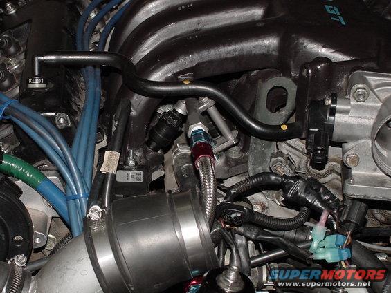 Engine fuel rail with braided line and injectors, intake manifold, and wiring harness