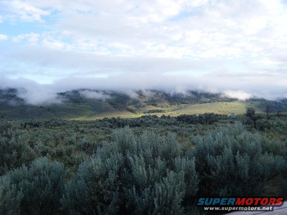 Misty mountains and sagebrush landscape with Supermotors watermark