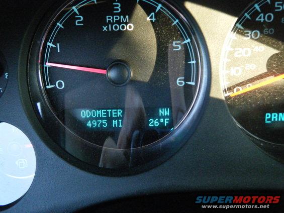 Dashboard gauges show odometer at 4975 miles, 26 degrees Fahrenheit, and RPMs