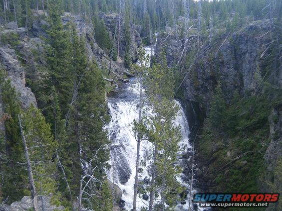 Waterfall cascading down rocks in a forest canyon