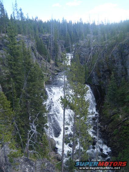 Waterfall cascading down rocks in a forest canyon