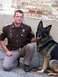 2003 Ford Crown Victoria - A police officer and his K-9 partner pose for a photo outside.