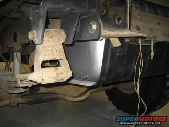 Underbody of a vehicle showing a fuel tank and suspension components