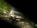 1992 Ford Bronco - Ford Bronco tackling an off-road trail with a person in the background.