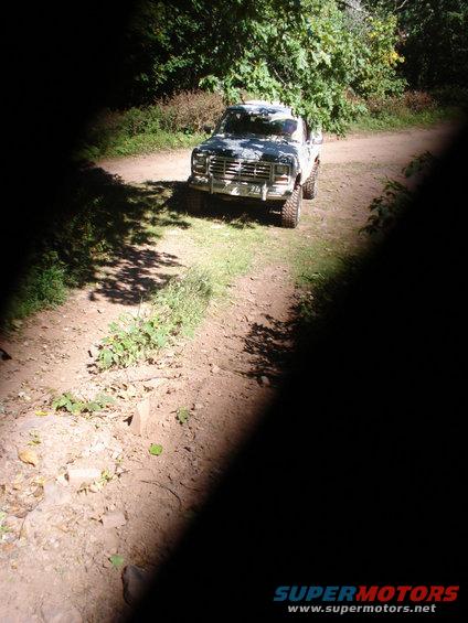1980s Ford F-Series truck front view on dirt road