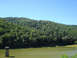 1992 Ford Bronco - Water reservoir and forested hill on a clear day. Supermotors.net logo visible.