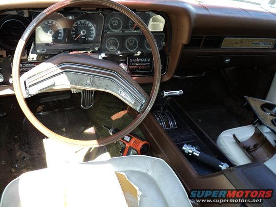 1974 Ford Elite interior showing brown dashboard, steering wheel, and center console with a Black & Decker drill