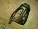 1997 Ford Probe - A black motorcycle exhaust muffler rests on a concrete surface, with a website logo in the corner.