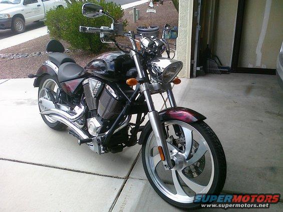 Motorcycle parked on a driveway in front of a garage