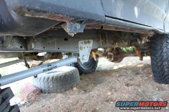 Close-up of vehicle undercarriage with custom suspension components and large tires