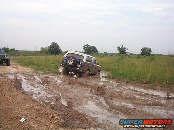 Ford Bronco stuck in mud, another Jeep nearby