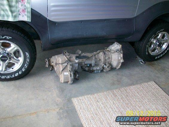 Transmission and transfer case assembly removed from vehicle