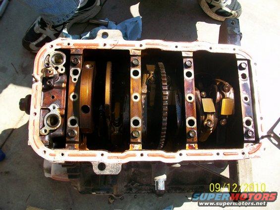 Engine oil pan removed, showing crankshaft and connecting rods