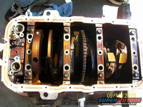 Engine oil pan removed, showing crankshaft and connecting rods