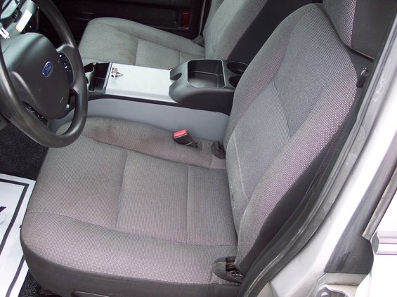 2001 Ford Crown Victoria police car interior showing front seats, steering wheel, and center console