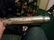 1995 Ford Bronco - A person holds a chrome SLP exhaust muffler, likely for a vehicle modification.