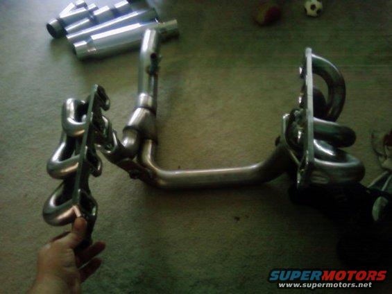Exhaust headers and pipes laid out on a floor