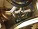 1995 Ford Bronco - Close-up view of an engine's exhaust manifold and associated wiring.
