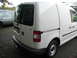 2009 Holden Commodore - A white Volkswagen Caddy panel van is seen from the rear, parked next to another vehicle.