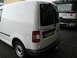 2009 Holden Commodore - A white Volkswagen Caddy van is parked behind a truck, showing its rear and side panels.