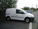 2009 Holden Commodore - A white panel van is parked in a lot next to another vehicle.