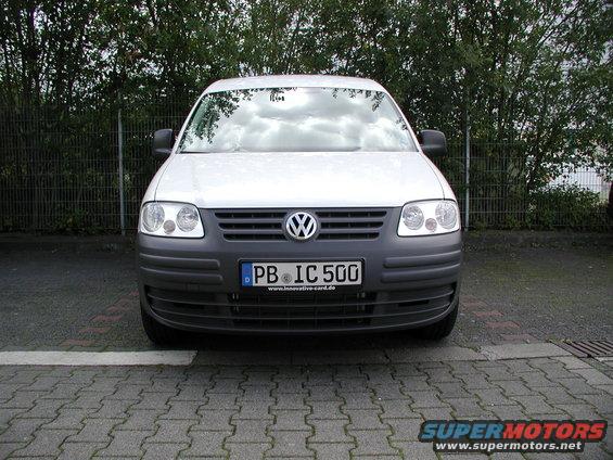Front view of a white Volkswagen Caddy van with license plate PB IC 500