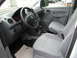 2009 Holden Commodore - The interior of a Volkswagen Caddy van shows the driver's seat, dashboard, and gear shifter.