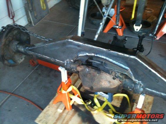 Vehicle axle assembly on jack stands, with chain attached to differential