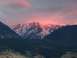2006 Ford E350 - Mountain range bathed in the warm glow of a sunset, with snow dusting the upper slopes.