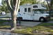 2005 Chevrolet Silverado 3500 - This RV is parked at a campsite, ready for an outdoor adventure. A picnic table and grill are set up nearby.