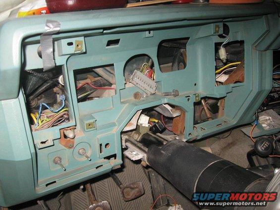 Disassembled dashboard showing wiring harness and steering column