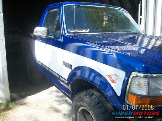 Blue and white 1993 Ford Bronco with red horse decal on fender
