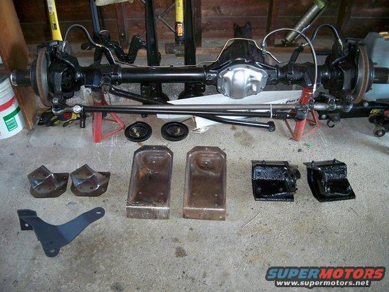 Front axle assembly and suspension parts on concrete floor