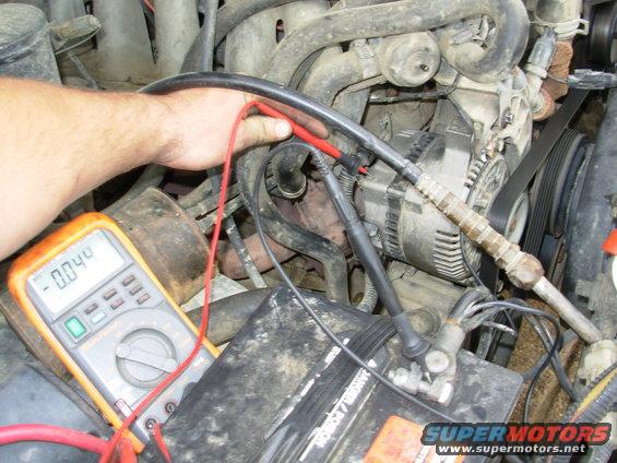 cont6.jpg The engine-running voltage between the alternator case & battery negative post immediately after cranking (which should ideally be zero) was almost 0.5 before I [url=http://www.crownvic.net/ubbthreads/ubbthreads.php?ubb=showflat&Number=2136757#Post2136757]cleaned the alternator mounting surfaces[/url], applied electrical (NOT dielectric) grease, and added that redundant ground straight from the battery clamp to the alternator upper mounting bolt.
IF THE IMAGE IS TOO SMALL, click it.

BTW
The black probe should actually be on the battery POST; not the clamp as shown.  But I only have 2 hands, and one is holding the camera. Polarity doesn't matter - if I reversed the probes, the value would be the same but the negative symbol would disappear from the display.

[url=https://www.supermotors.net/registry/media/1077817][img]https://www.supermotors.net/getfile/1077817/thumbnail/rs22172dmm.jpg[/img][/url] . [url=https://www.supermotors.net/registry/media/825375][img]https://www.supermotors.net/getfile/825375/thumbnail/alternatormountboss.jpg[/img][/url] . [url=https://www.supermotors.net/registry/media/843907][img]https://www.supermotors.net/getfile/843907/thumbnail/alternator3gvr.jpg[/img][/url] . [url=https://www.supermotors.net/registry/media/1055206][img]https://www.supermotors.net/getfile/1055206/thumbnail/06bracket01.jpg[/img][/url] . [url=https://www.supermotors.net/registry/media/1055207][img]https://www.supermotors.net/getfile/1055207/thumbnail/06bracket02.jpg[/img][/url]
___________________________________________________
&quot;Grounding&quot; is commonly misunderstood...

When electricity first became publicly available (when Edison & Tesla were fighting over DC vs. AC), Copper wire was very expensive. So rather than run 2 wires everywhere, Tesla realized he could run a &quot;hot&quot; wire, and then use the ground (the actual dirt of the Earth) as the return circuit path. (He also thought he could use the ionosphere as the hot side, but he never got that to work.)  Inside a house, there still had to be 2 wires, but one of them went &quot;to the ground&quot; via a Copper rod driven into the dirt outside the house. That became known as &quot;the ground wire&quot;. When vehicles acquired electric circuits (AFAIK, the first on any Ford was the electric horn, which Ford always numbers as circuit #1), it was equally-efficient to use the metal chassis of the vehicle as one the main electrical pathway, to reduce the amount of wire needed. And the term &quot;ground&quot; was carried over into that arena. Chassis grounding worked reasonably-well until alternators got up into the ~100A range (in the 80s) and vehicle wiring harnesses began to exceed the weight of the drivetrain (AFAIK, the first to cross that line was the '92 Lincoln Continental V6). Since then, more circuits are networked through high-speed data bus lines via communication modules so that you don't need a discrete wire running from one end of the vehicle to the other & another coming back to turn on a taillight, and confirm that the bulb isn't burnt out.

But as a result, the chassis/body ground is no longer sufficient to provide a reliable circuit path without introducing a lot of background noise (RFI) into those minuscule high-frequency data signals. So the trend for a couple of decades now has been to run actual Copper return wires so that far less current flows through the chassis steel. (House wiring standards added a return &quot;neutral&quot; wire decades before that.)

So by definition, if you're using a wire to return to the battery, you're not &quot;grounding&quot; that circuit - you're wiring it. And wiring it is a good idea when you're dealing with rusty 40- to 50-year-old body & frame steel. The catch is that the return wiring has to be AT LEAST as large as ALL the power wiring that it serves - IOW, very big like the alternator output wire, the starter wire, the winch wiring, and the ignition switch battery-supply wires. None of it needs to be bigger than the battery cables because you can't ever get more current flowing than the battery can put out (roughly whatever its CA rating is).

So if you want to be sure you have a good return path throughout any vehicle, just extend the battery (-) cable all the way to the trailer connector. Obviously, you can't run a cable that big into the trailer connector or anything else - you have to splice onto it to branch off with smaller black wire (or whatever color the particular circuit uses for &quot;ground&quot;). That's why I refer to that as a &quot;trunk ground&quot; system - the main return wire is like a big tree trunk, with the variously-sized smaller branches shooting out to hit each point on the vehicle that needs an exceptionally-reliable return (generally: the high-current devices; and those that require low RFI noise, like audio amplifiers).

Fortunately, those splices DON'T need to be insulated - they can be left showing bare metal. Copper & solder don't corrode very quickly in air, or even in common rainwater. Mainly just at the battery where acid leaks out. Road salt will eventually cause some corrosion, but probably not enough to matter within the remaining lifespan of even the best-maintained antiques.

And the body & frame should still be GROUNDED at a few points, just to reduce galvanic corrosion, and to serve the very-low-current chassis-grounded loads like taillights & fuel level senders.
