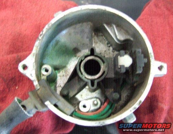 Inside of a car distributor cap with wires and a rotor mechanism