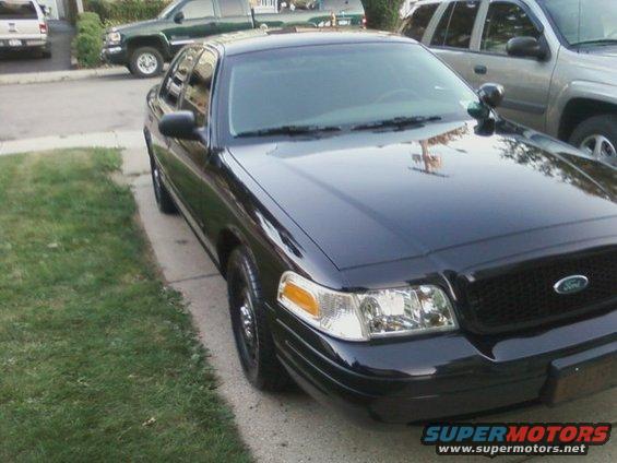 Black 2003 Ford Crown Victoria parked on a driveway, front quarter view