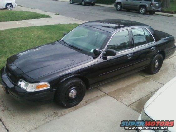 Black 2003 Ford Crown Victoria sedan parked on driveway