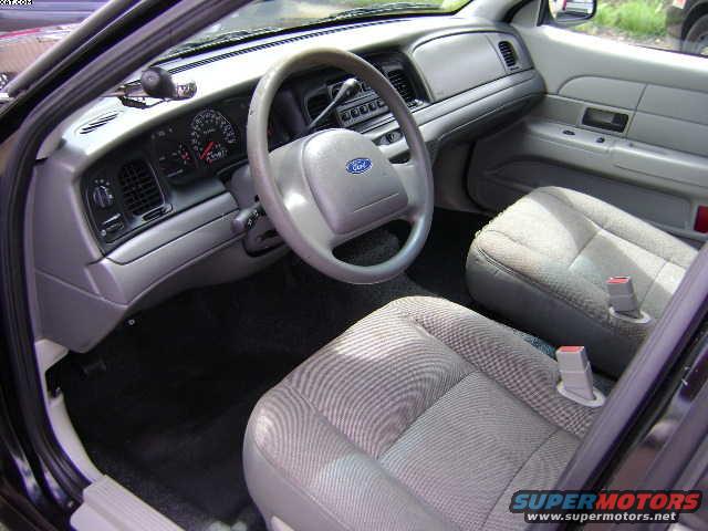 Interior view of a 2003 Ford Crown Victoria, showing the dashboard, steering wheel, and front seats
