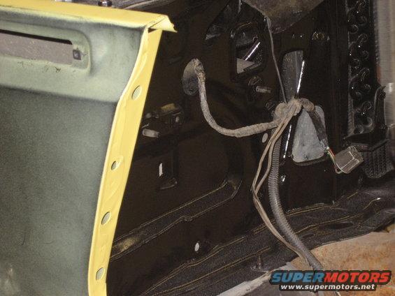 Interior of vehicle with yellow taped door frame and exposed wiring