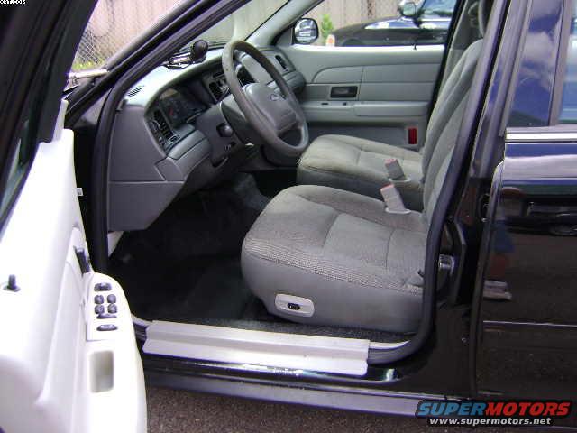 Interior view of a 2003 Ford Crown Victoria, showing the front seats, dashboard, and steering wheel