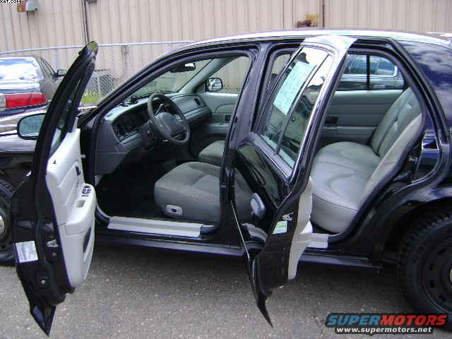 Interior of a 2003 Ford Crown Victoria with front and rear doors open
