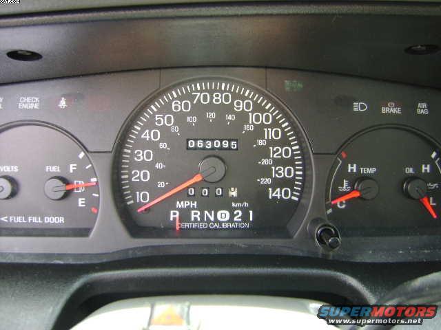 2003 Ford Crown Victoria dashboard with speedometer, odometer, fuel gauge, temperature gauge, and oil pressure gauge