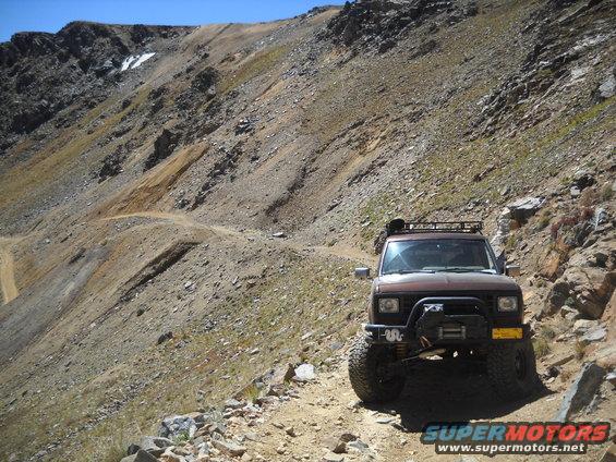Brown 1986 Ford Bronco II on a rocky mountain trail
