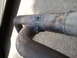 2003 Acura TL - Close-up of a damaged exhaust pipe, showing holes and weld repairs.