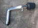 2003 Acura TL - A performance intake system part is shown lying on a concrete surface.
